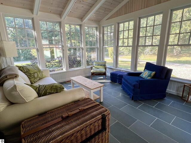 sunroom / solarium featuring an outdoor living space, a healthy amount of sunlight, and beam ceiling