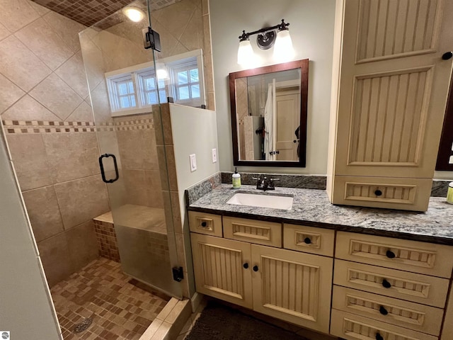 full bathroom featuring a stall shower and vanity