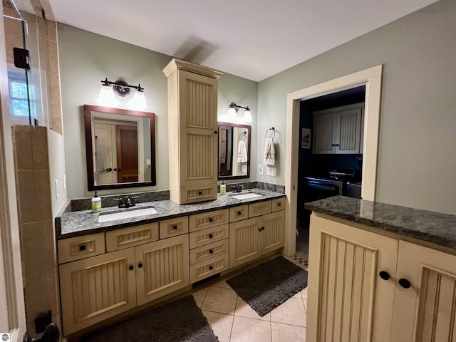 bathroom featuring tile patterned flooring, double vanity, a sink, and a stall shower