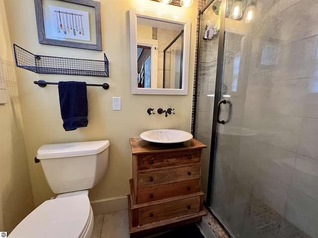 full bathroom featuring a shower stall, vanity, tile patterned flooring, toilet, and baseboards