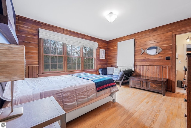 bedroom with wood finished floors and wooden walls