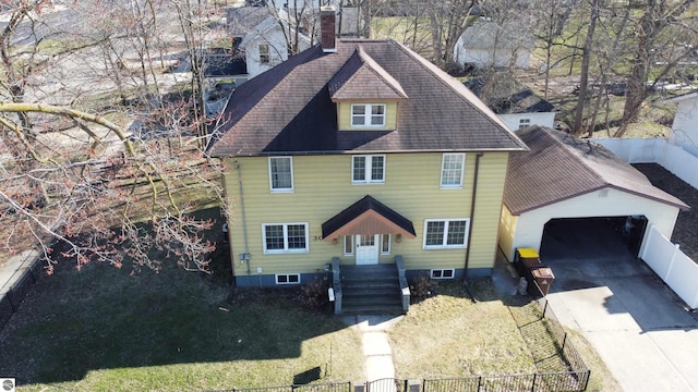 303 W Washington Ave, Saint Louis, MI 48880 - colonial inspired home featuring a chimney, a shingled roof, driveway, and a fenced front yard