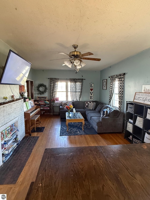 303 W Washington Ave, Saint Louis, MI 48880 - living room featuring a textured ceiling, wood finished floors, and ceiling fan