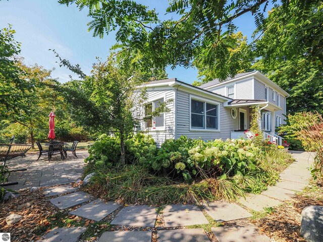 view of side of property with a patio