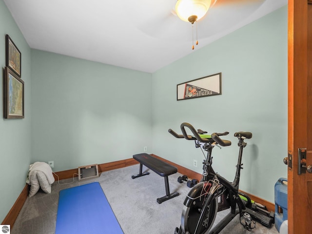 exercise area featuring baseboards, a ceiling fan, and carpet flooring