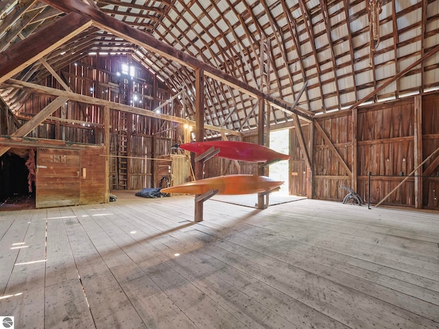 miscellaneous room featuring high vaulted ceiling and hardwood / wood-style floors