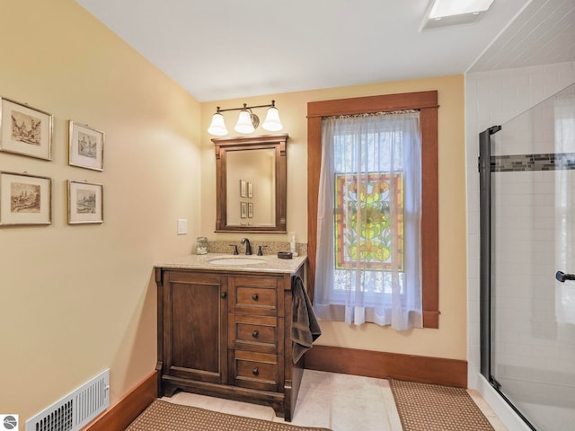 full bath featuring vanity, baseboards, tile patterned flooring, a shower stall, and visible vents
