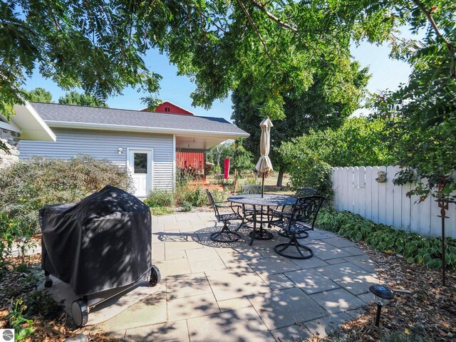 view of patio / terrace with outdoor dining space, grilling area, and fence