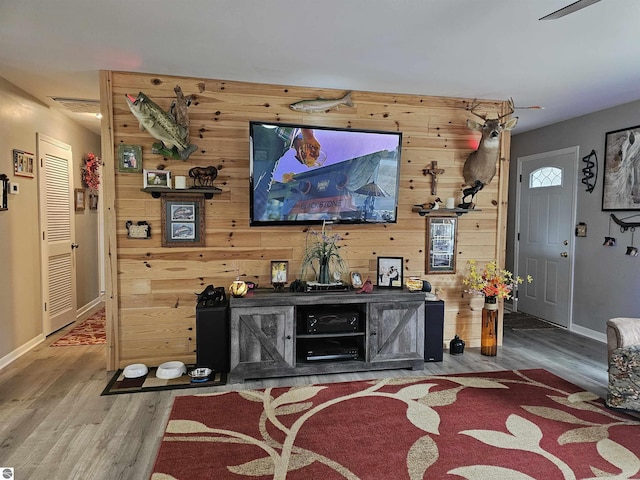 3042 Brodie Rd, South Branch, MI 48761 - living area with wood finished floors, wooden walls, baseboards, and visible vents