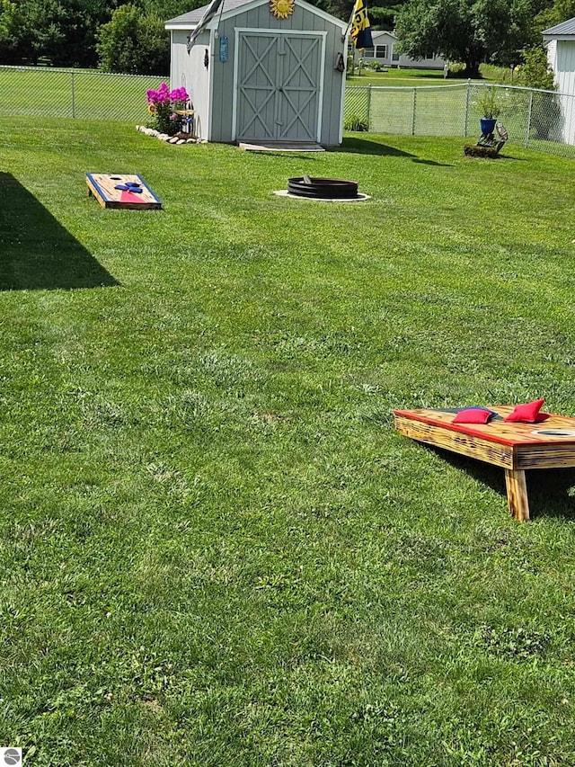 3042 Brodie Rd, South Branch, MI 48761 - view of yard featuring a shed, fence, and an outbuilding