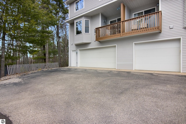 exterior space with a garage, driveway, and fence