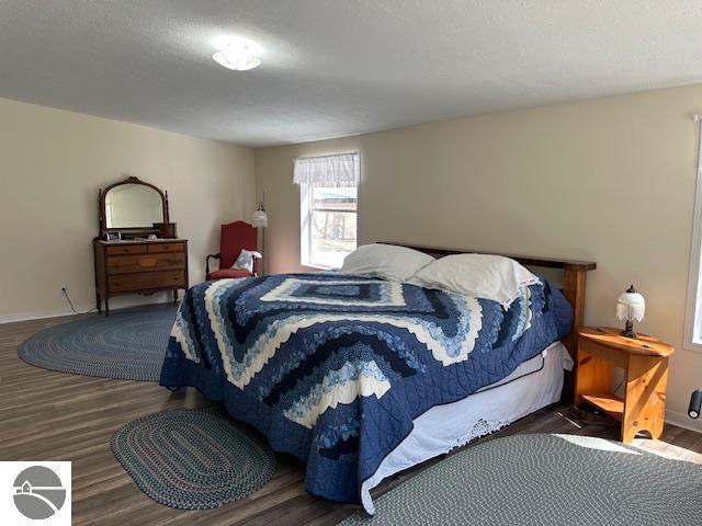 bedroom featuring baseboards and wood finished floors