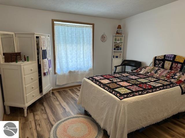 bedroom with wood finished floors
