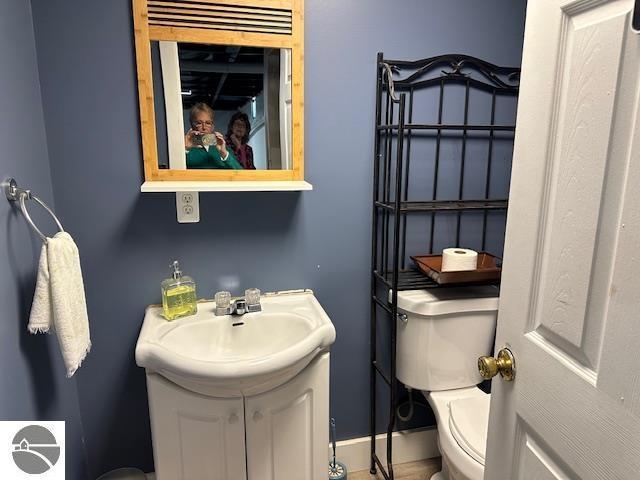 bathroom featuring toilet and vanity