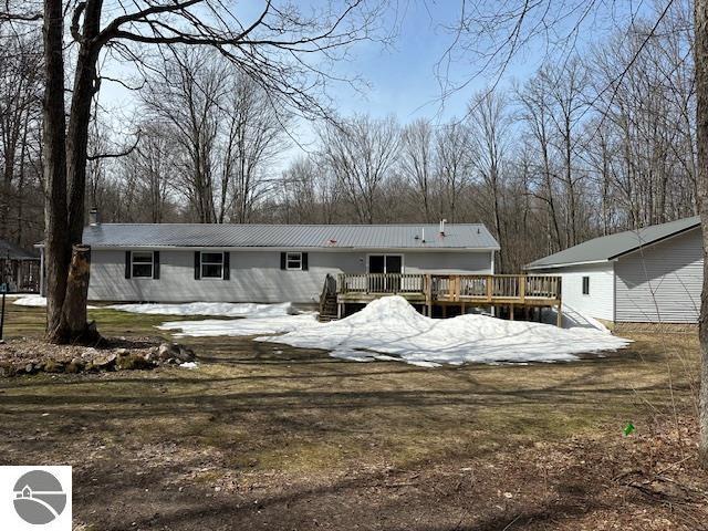 back of house featuring a wooden deck
