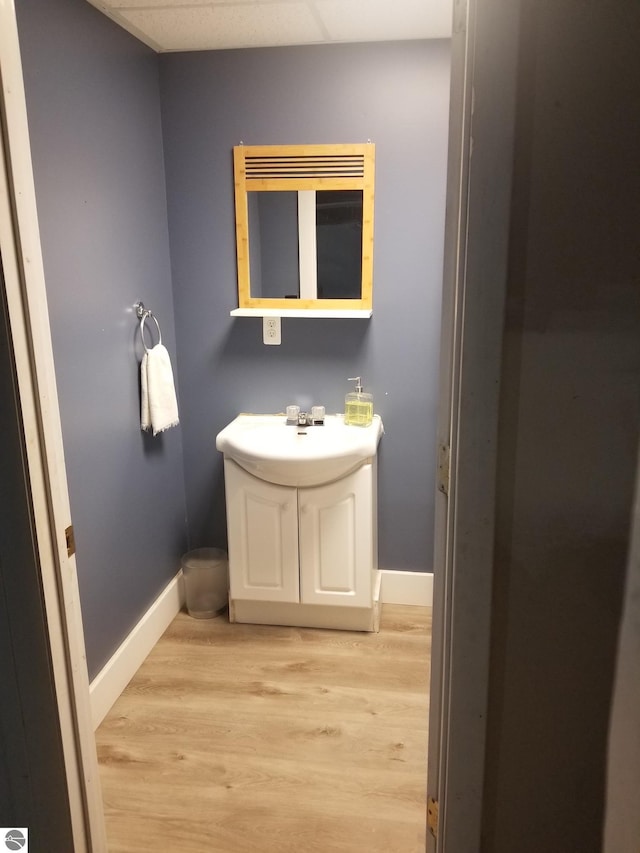bathroom featuring baseboards, vanity, and wood finished floors