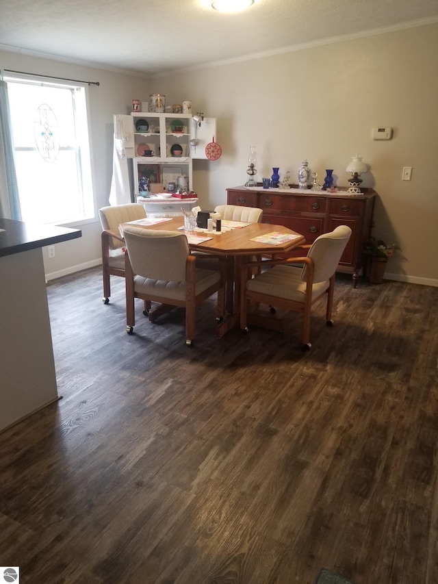 dining space with crown molding, baseboards, and dark wood-style flooring