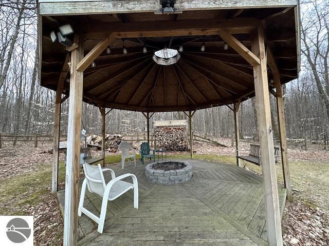 deck featuring a gazebo and an outdoor fire pit