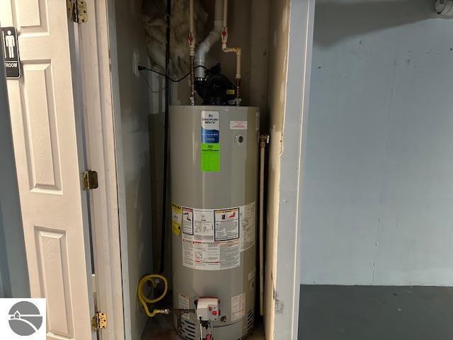 utility room featuring gas water heater