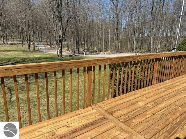 4607 Del Mason Rd, Bellaire, MI 49615 - wooden deck featuring a lawn