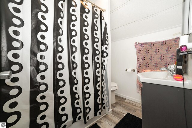 full bathroom with toilet, a shower with curtain, vanity, and wood finished floors