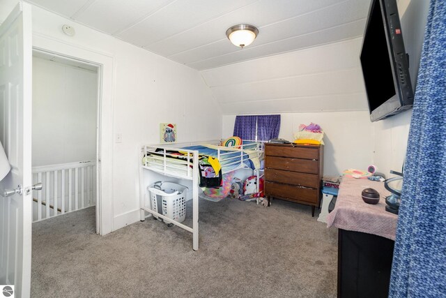 carpeted bedroom featuring lofted ceiling