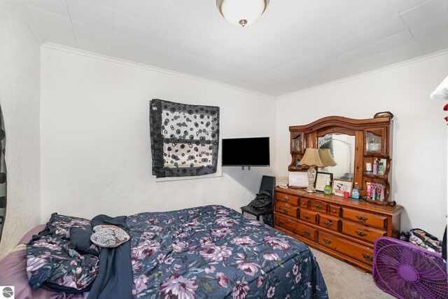 carpeted bedroom with ornamental molding