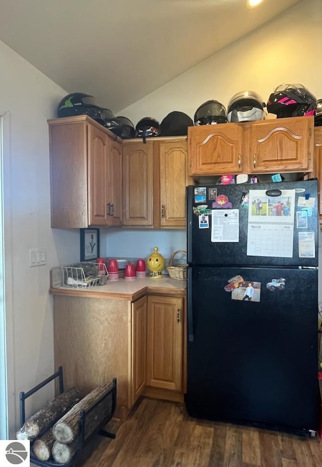 5071 Corey Rd, Mancelona, MI 49659 - kitchen featuring light countertops, freestanding refrigerator, vaulted ceiling, and dark wood-style floors