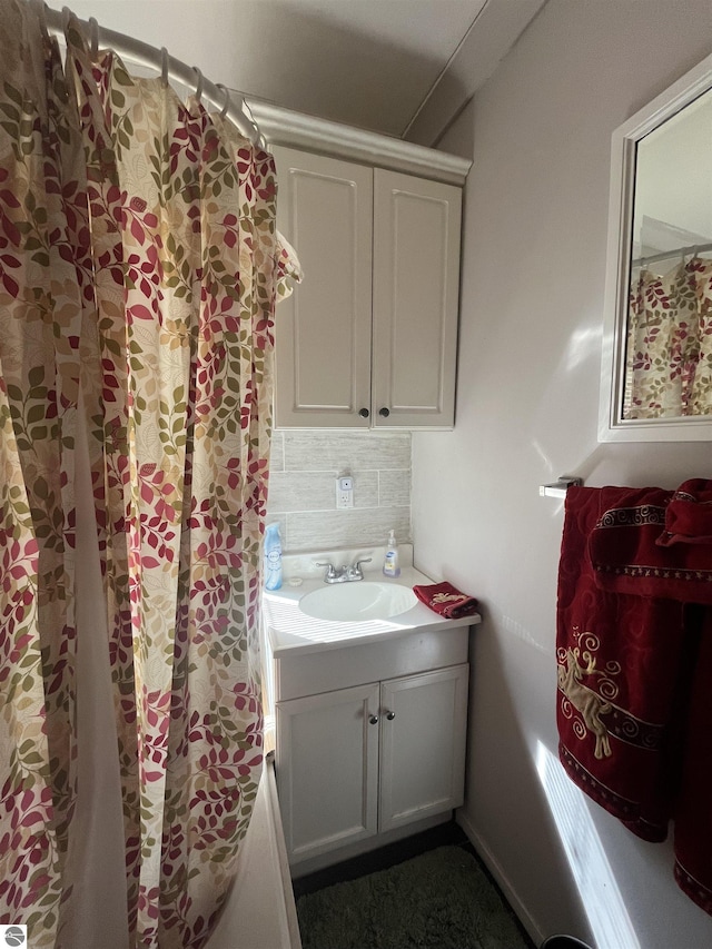 5071 Corey Rd, Mancelona, MI 49659 - bathroom with backsplash and vanity