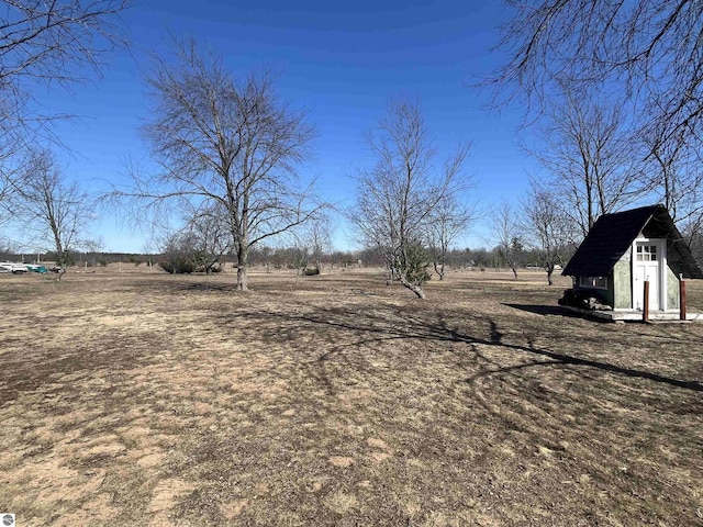 5071 Corey Rd, Mancelona, MI 49659 - view of yard with an outdoor structure and a storage shed