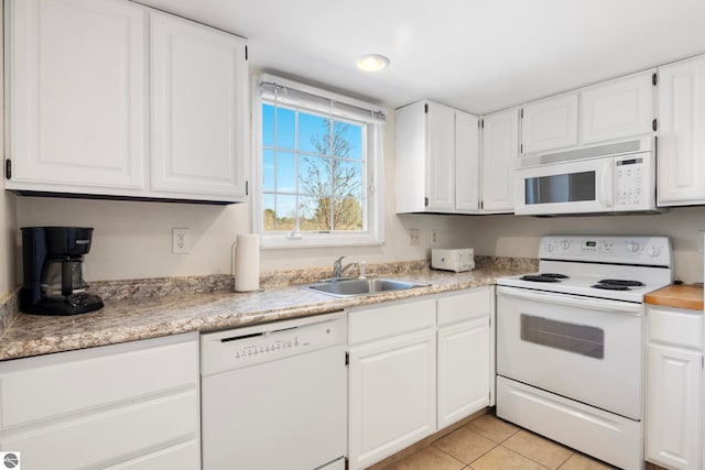 5000 Townhouse Dr, Cedar, MI 49621 - kitchen featuring a sink, light countertops, white appliances, and white cabinets