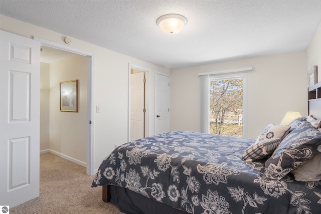 5000 Townhouse Dr, Cedar, MI 49621 - carpeted bedroom with baseboards and a textured ceiling