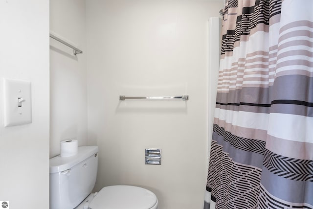 5000 Townhouse Dr, Cedar, MI 49621 - bathroom featuring curtained shower and toilet