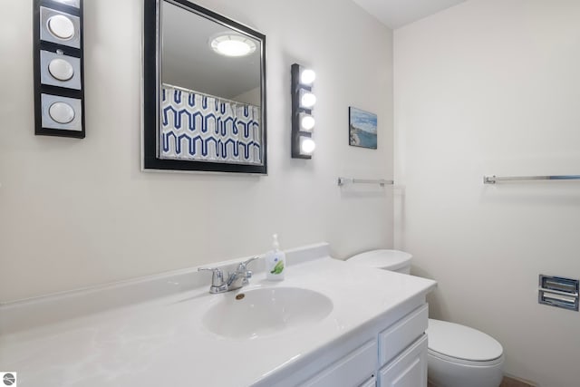 5000 Townhouse Dr, Cedar, MI 49621 - bathroom with curtained shower, vanity, and toilet