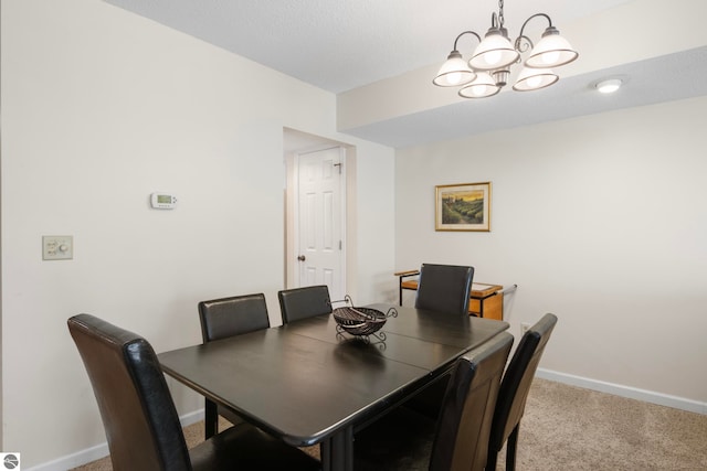 5000 Townhouse Dr, Cedar, MI 49621 - dining room featuring a chandelier, baseboards, and carpet