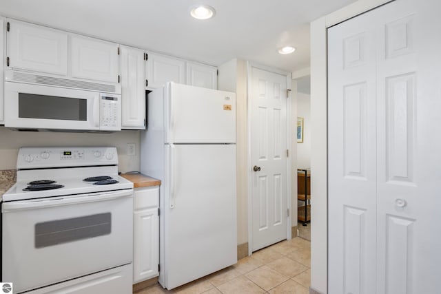 5000 Townhouse Dr, Cedar, MI 49621 - kitchen with white appliances, white cabinetry, light countertops, and light tile patterned flooring