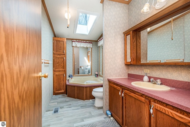 full bathroom with vaulted ceiling with skylight, toilet, wood finished floors, and wallpapered walls
