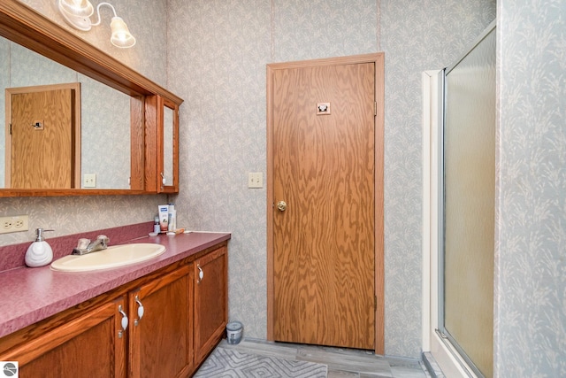 bathroom featuring tile patterned flooring, vanity, and a stall shower