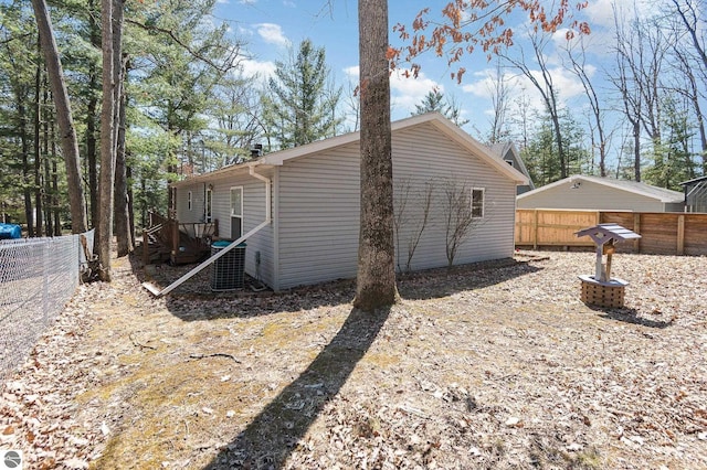 view of side of home with a fenced backyard and a deck