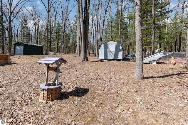 view of yard featuring a storage shed and an outbuilding