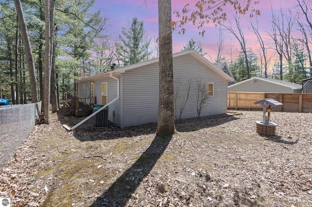property exterior at dusk with a fenced backyard