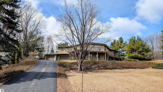 view of front of property featuring a deck and driveway