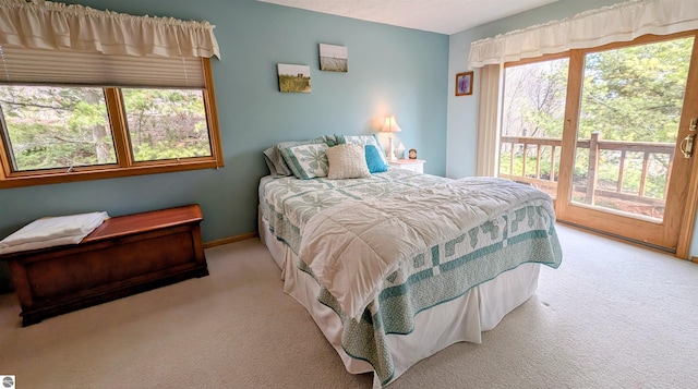 carpeted bedroom featuring access to outside and baseboards