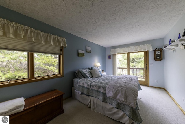 carpeted bedroom featuring baseboards, access to outside, and a textured ceiling