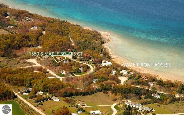 birds eye view of property with a view of the beach and a water view
