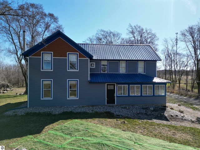 2587 S Coldwater Rd, Mount Pleasant, MI 48858 - back of house with metal roof and a lawn