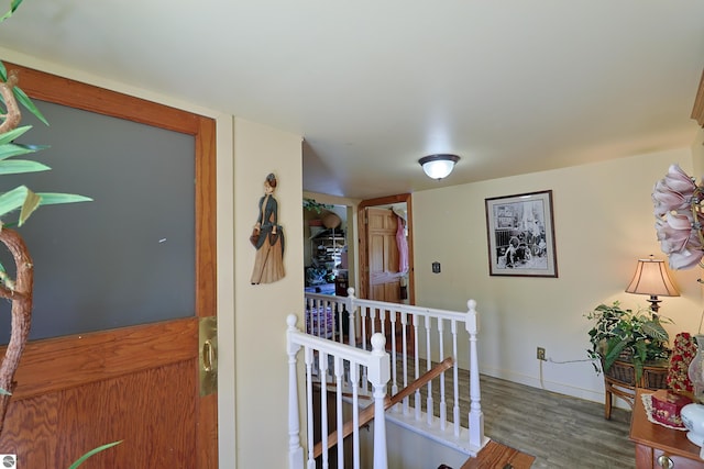 2587 S Coldwater Rd, Mount Pleasant, MI 48858 - corridor featuring baseboards, an upstairs landing, and wood finished floors
