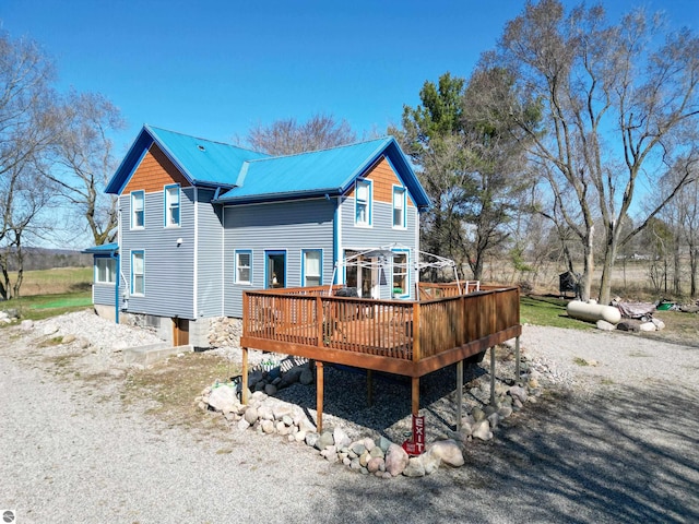 2587 S Coldwater Rd, Mount Pleasant, MI 48858 - rear view of house featuring metal roof and a wooden deck