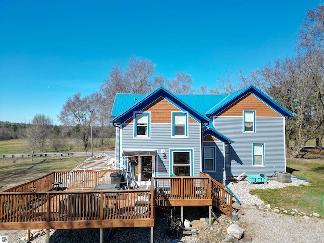 2587 S Coldwater Rd, Mount Pleasant, MI 48858 - back of property featuring central AC, a wooden deck, and metal roof