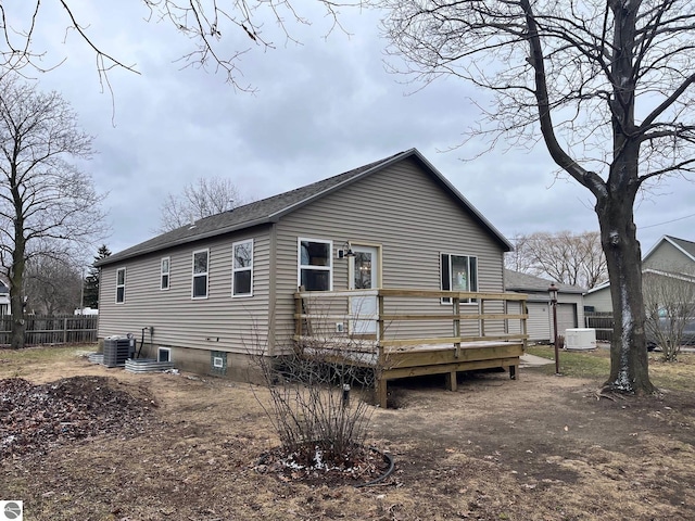 back of house featuring central air condition unit, a wooden deck, fence, and roof with shingles